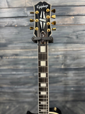 Epiphone electric guitar headstock on a wooden surface