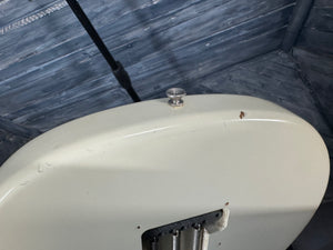 Close-up of a white object with metallic components against a textured blue background