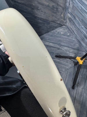 Close-up of a white scooter seat with a blurred background