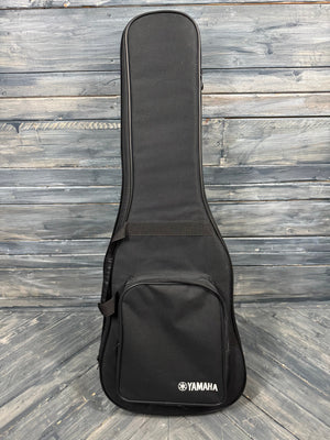 Black Yamaha guitar case on a wooden floor