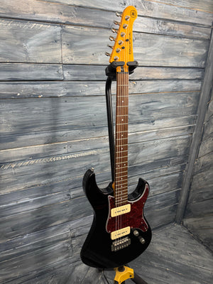 Electric guitar with a black and orange design on a wooden floor