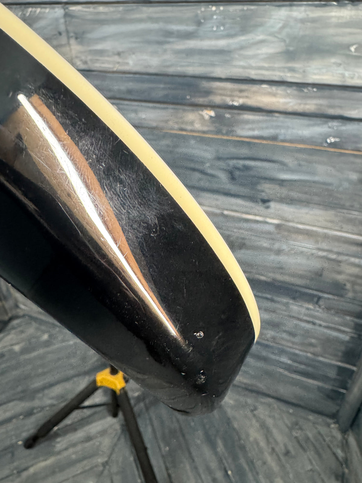 Close-up of a black and beige object on a wooden surface