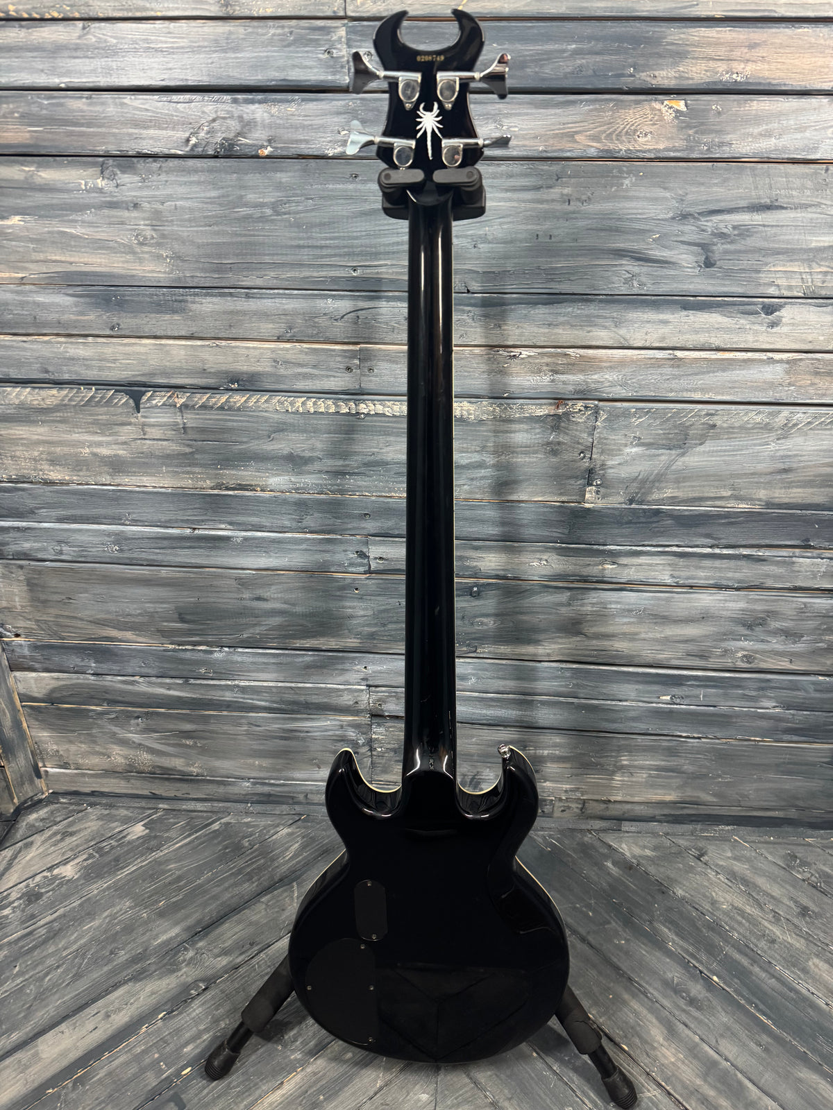 Black electric guitar on a wooden floor
