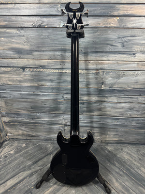 Black electric guitar on a wooden floor