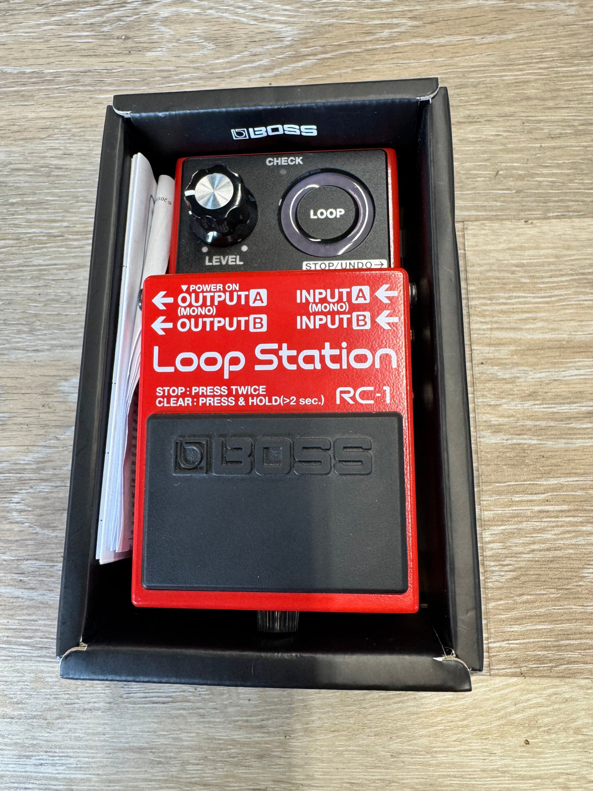 Boss Loop Station RC-1 guitar effects pedal in its packaging on a wooden surface