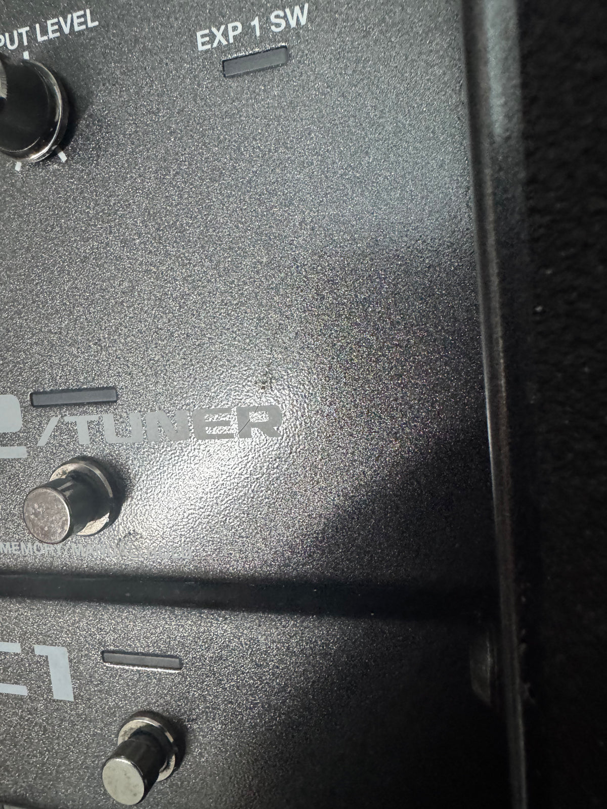 Close-up of a black electronic device with 'Tubber' branding and control knobs.