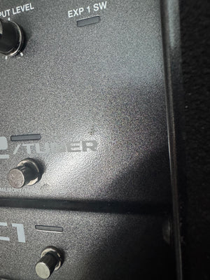 Close-up of a black electronic device with 'Tubber' branding and control knobs.