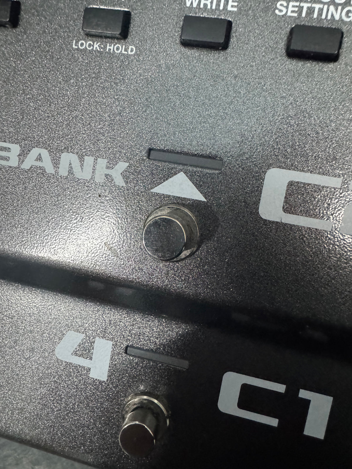 Close-up of a control panel with buttons and labels on a metallic surface.