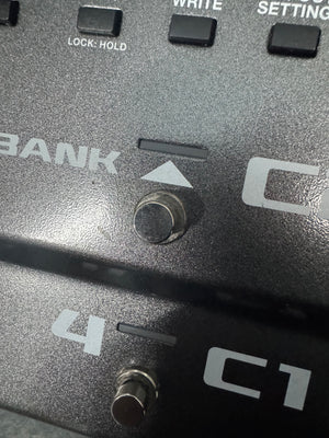 Close-up of a control panel with buttons and labels on a metallic surface.