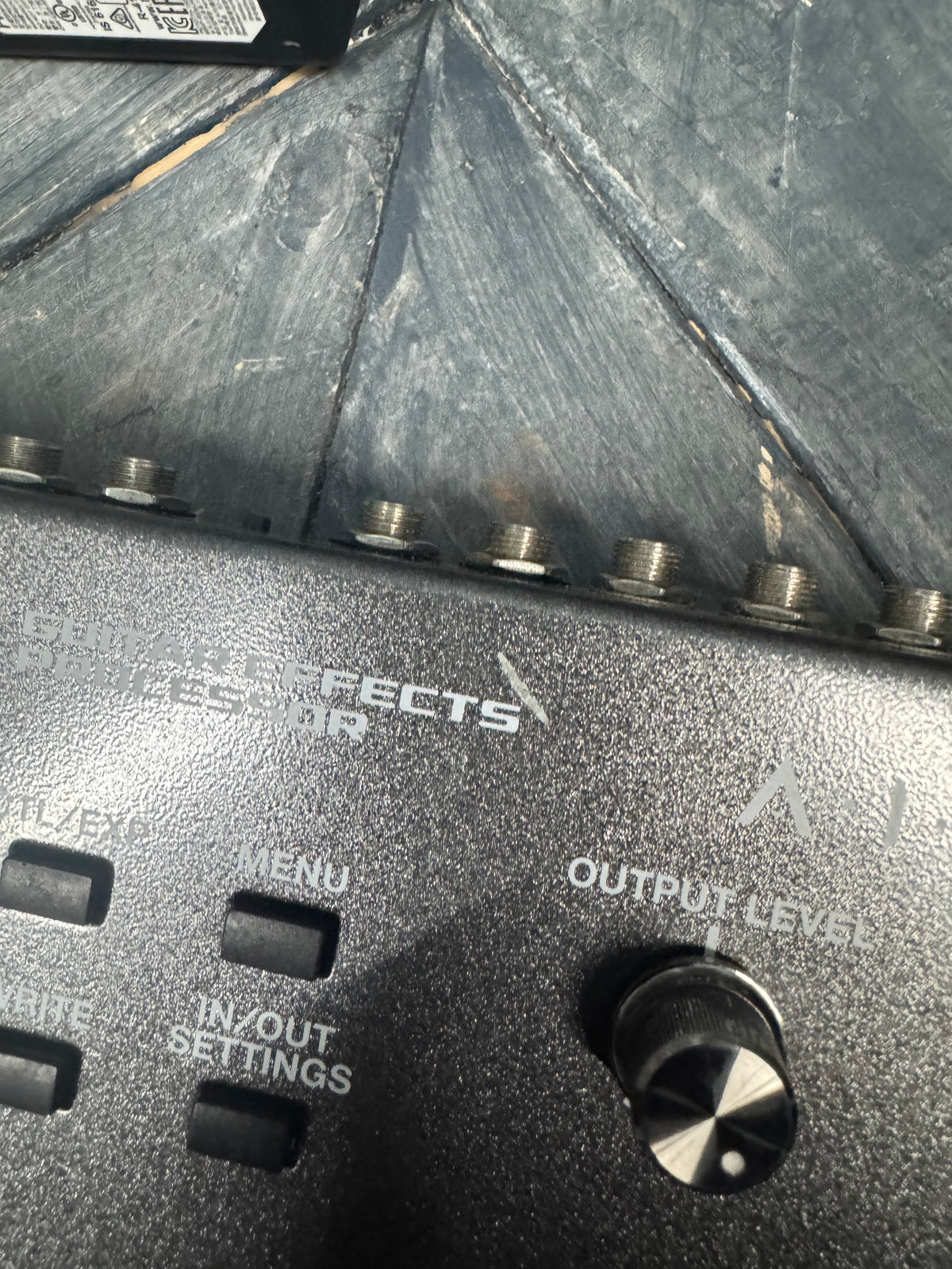 Close-up of a sound effects processor with visible branding and control elements.