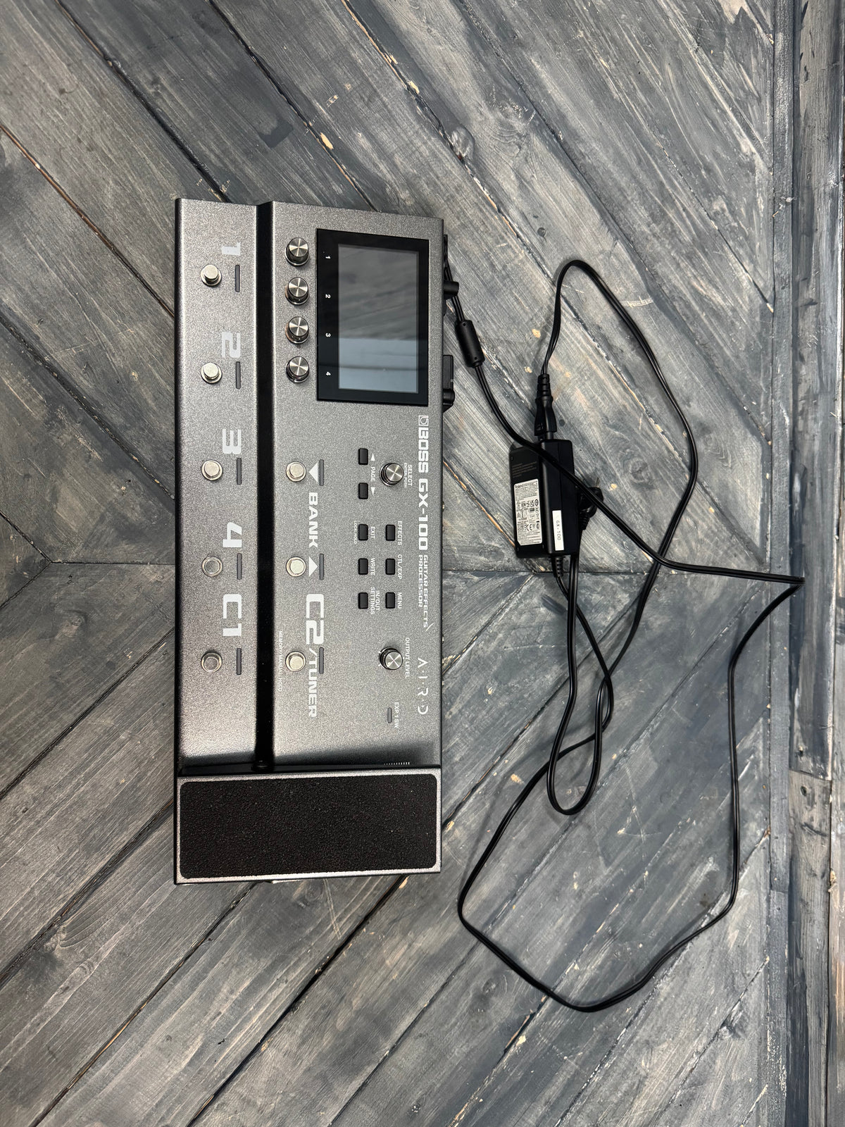 Electronic device with a power cable on a wooden surface