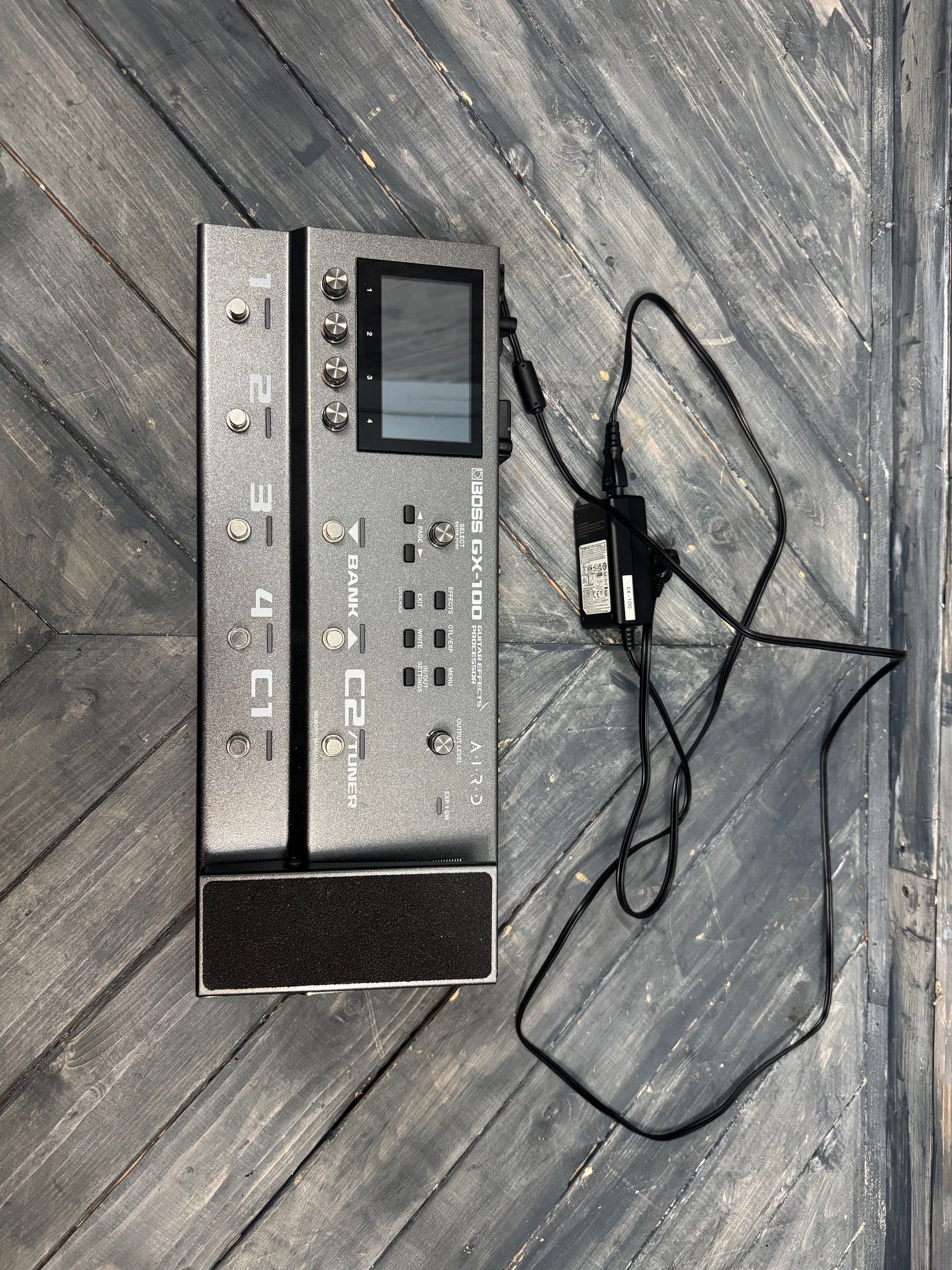 Electronic device with a power cable on a wooden surface