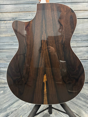 Close-up of a wooden guitar body on a wooden floor