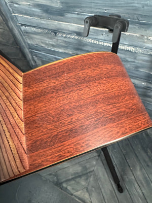 Close-up of a wooden guitar body with a blurred background
