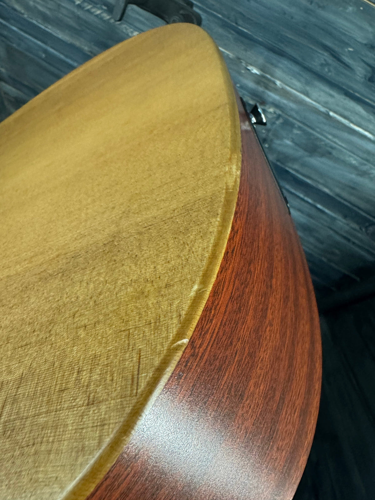 Close-up of a wooden surface with a dark brown top and light brown bottom.