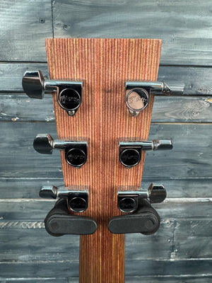 Wooden guitar wall hanger with metal hooks against a wooden background