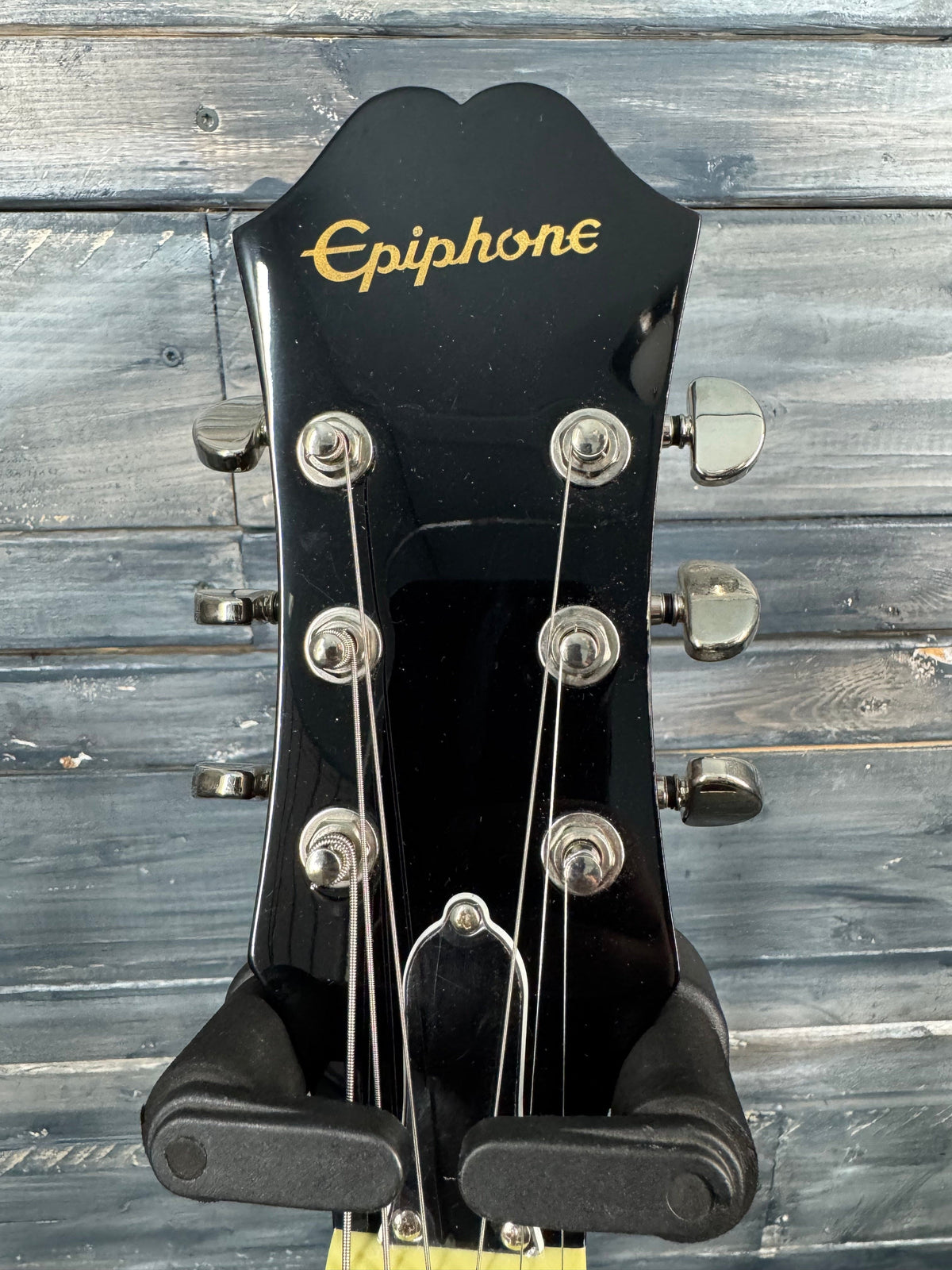 Gibson guitar headstock on a wooden background