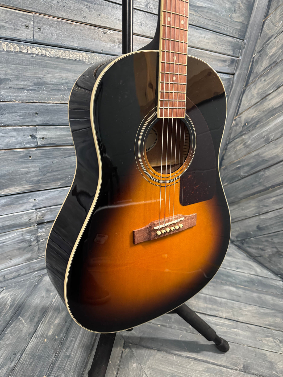 Acoustic guitar on a wooden deck