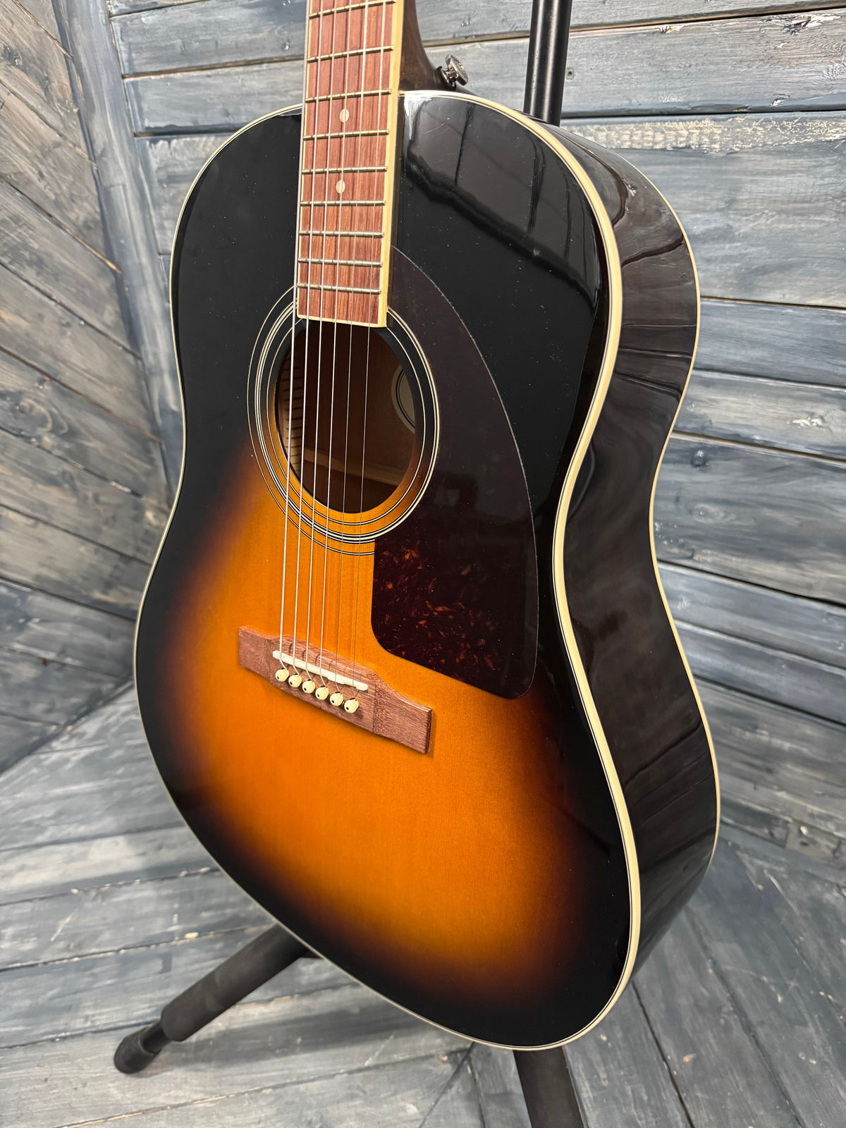 Acoustic guitar with a sunburst finish on a wooden surface