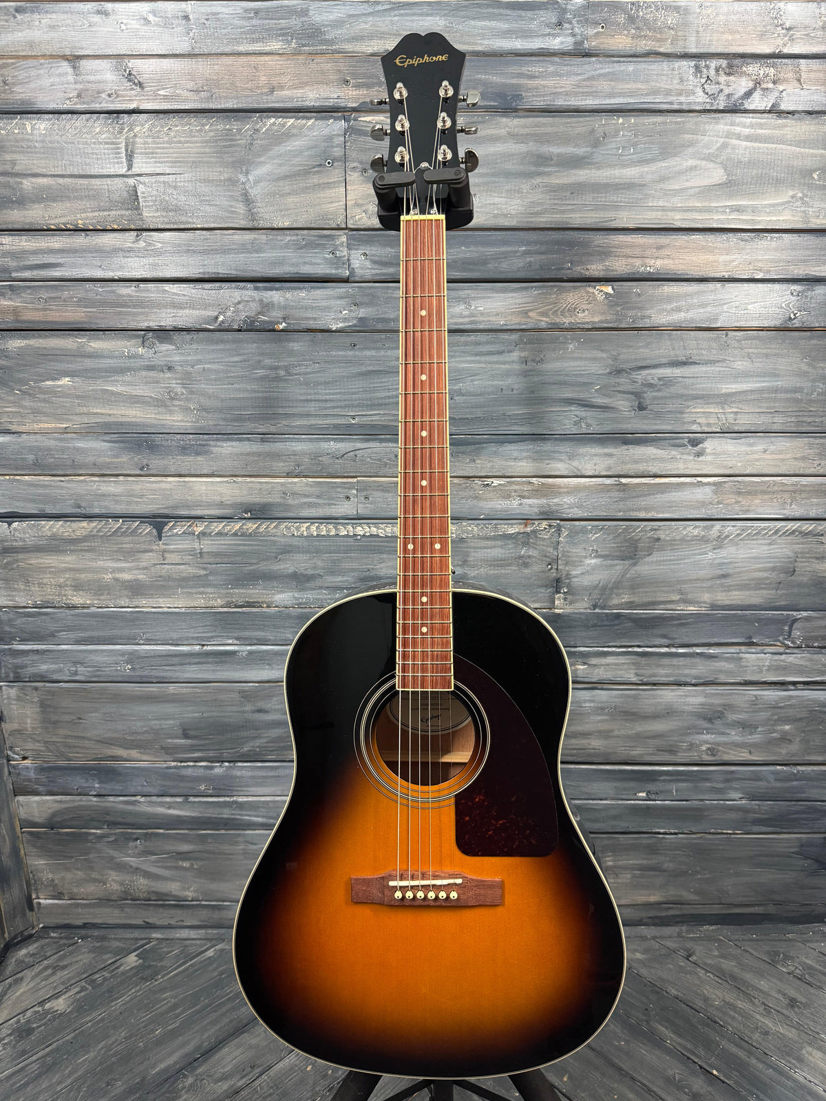 Acoustic guitar with a sunburst finish on a wooden background