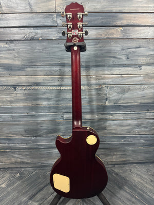 Guitar with a maroon finish on a wooden surface