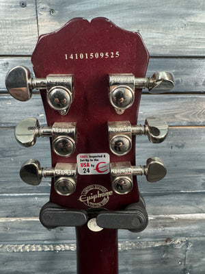 Gibson guitar headstock with tuning pegs on a wooden background