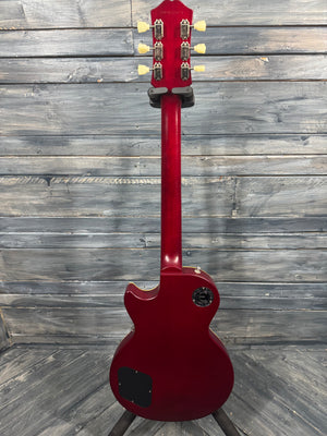 Red electric guitar on a wooden floor