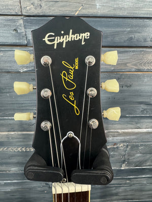 Epiphone Les Paul guitar headstock on a wooden background