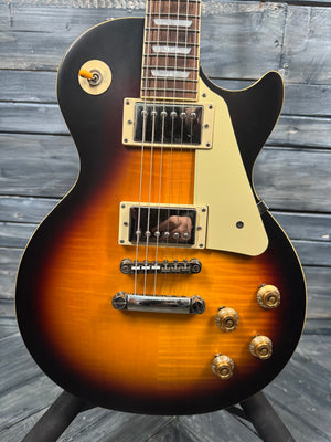 Electric guitar with a sunburst finish on a wooden background