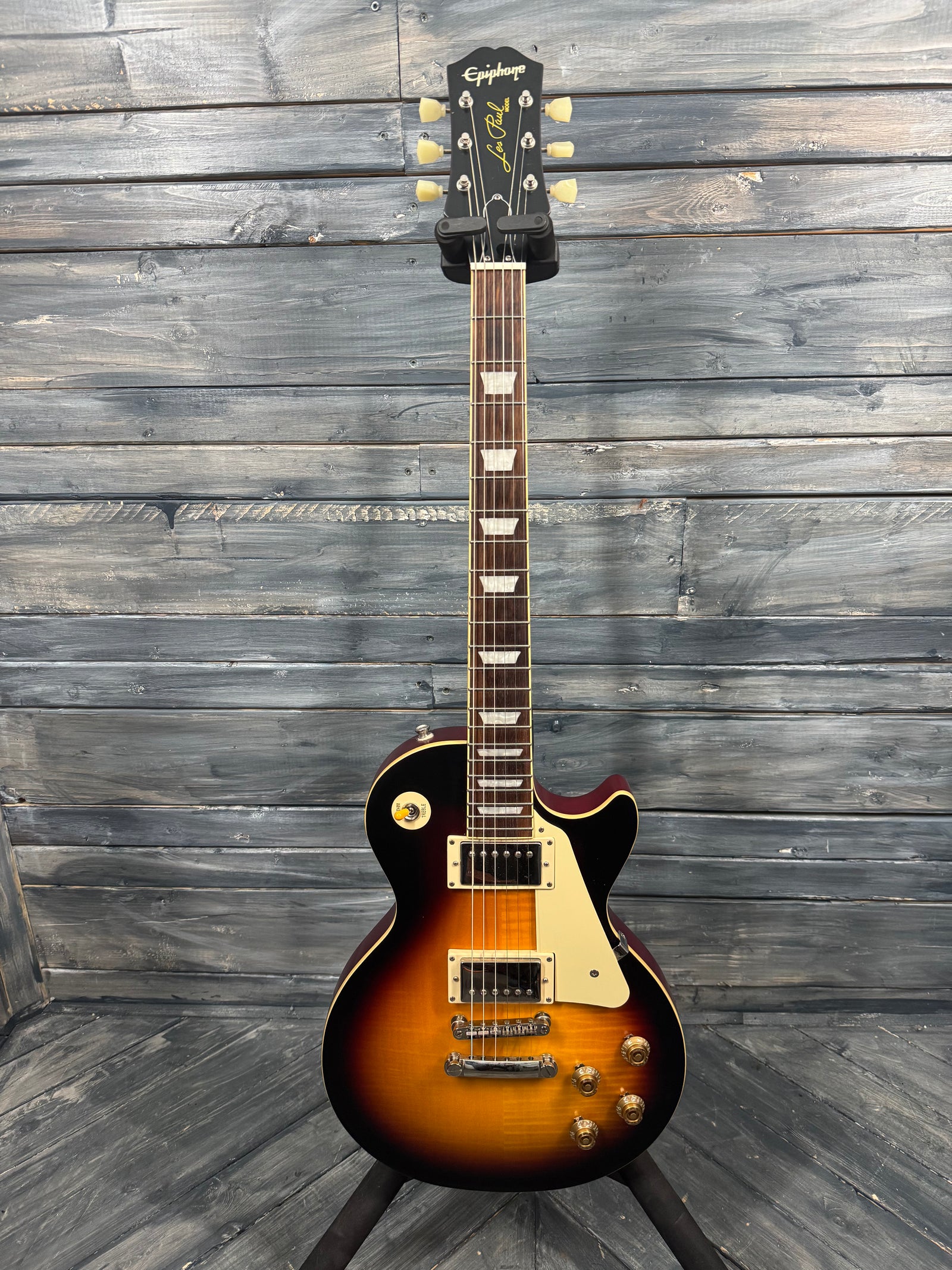 Electric guitar with a sunburst finish on a wooden background