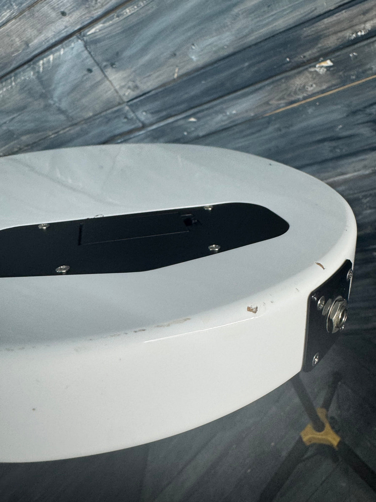 Close-up of a white circular object with black center on a textured gray background