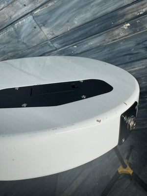 Close-up of a white circular object with black center on a textured gray background