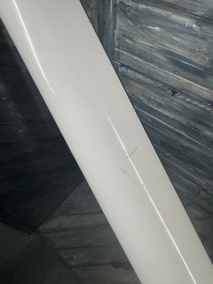 Close-up of a white tiled edge against a dark marble wall