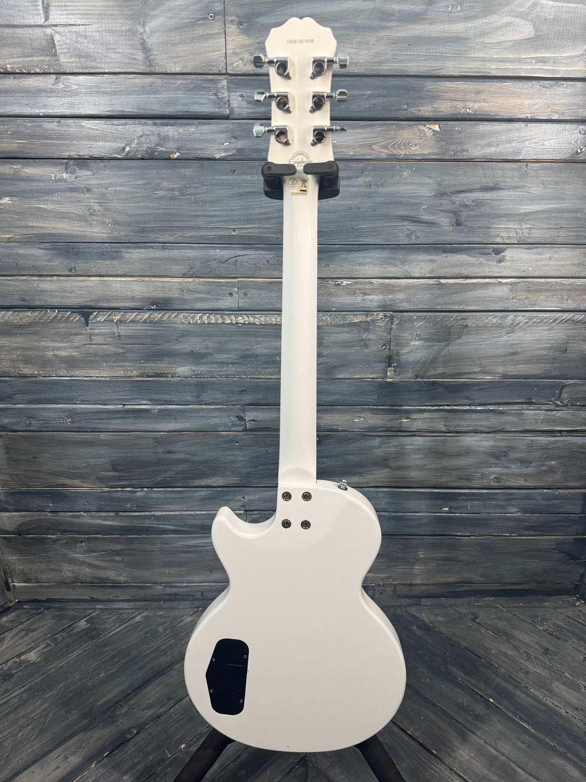 White electric guitar on a wooden surface