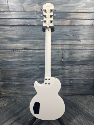 White electric guitar on a wooden surface