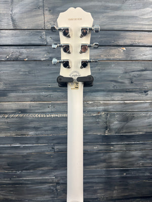 White guitar neck with tuning pegs on a wooden surface