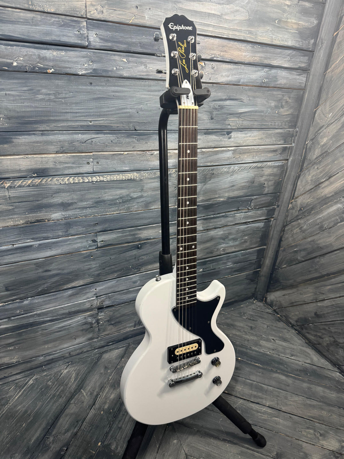 White electric guitar on a wooden floor
