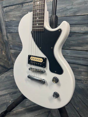 White electric guitar on a wooden surface
