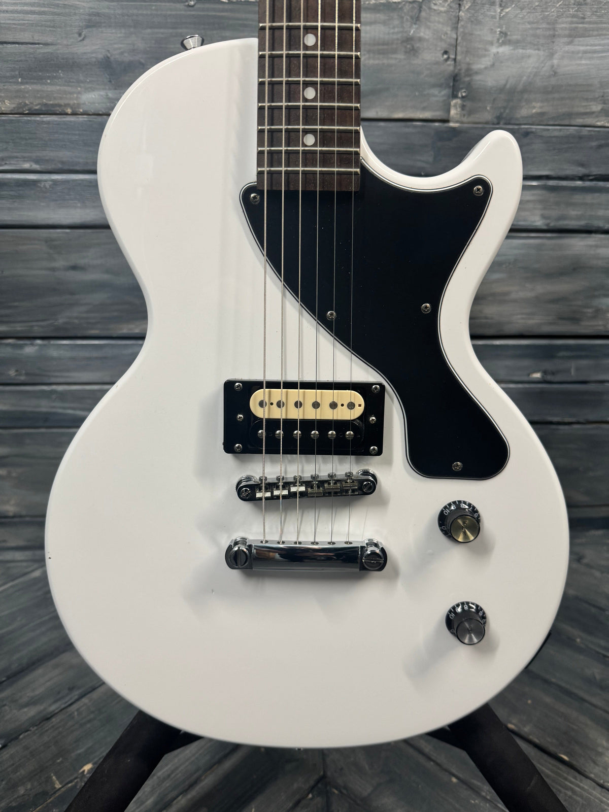 White electric guitar on a wooden background