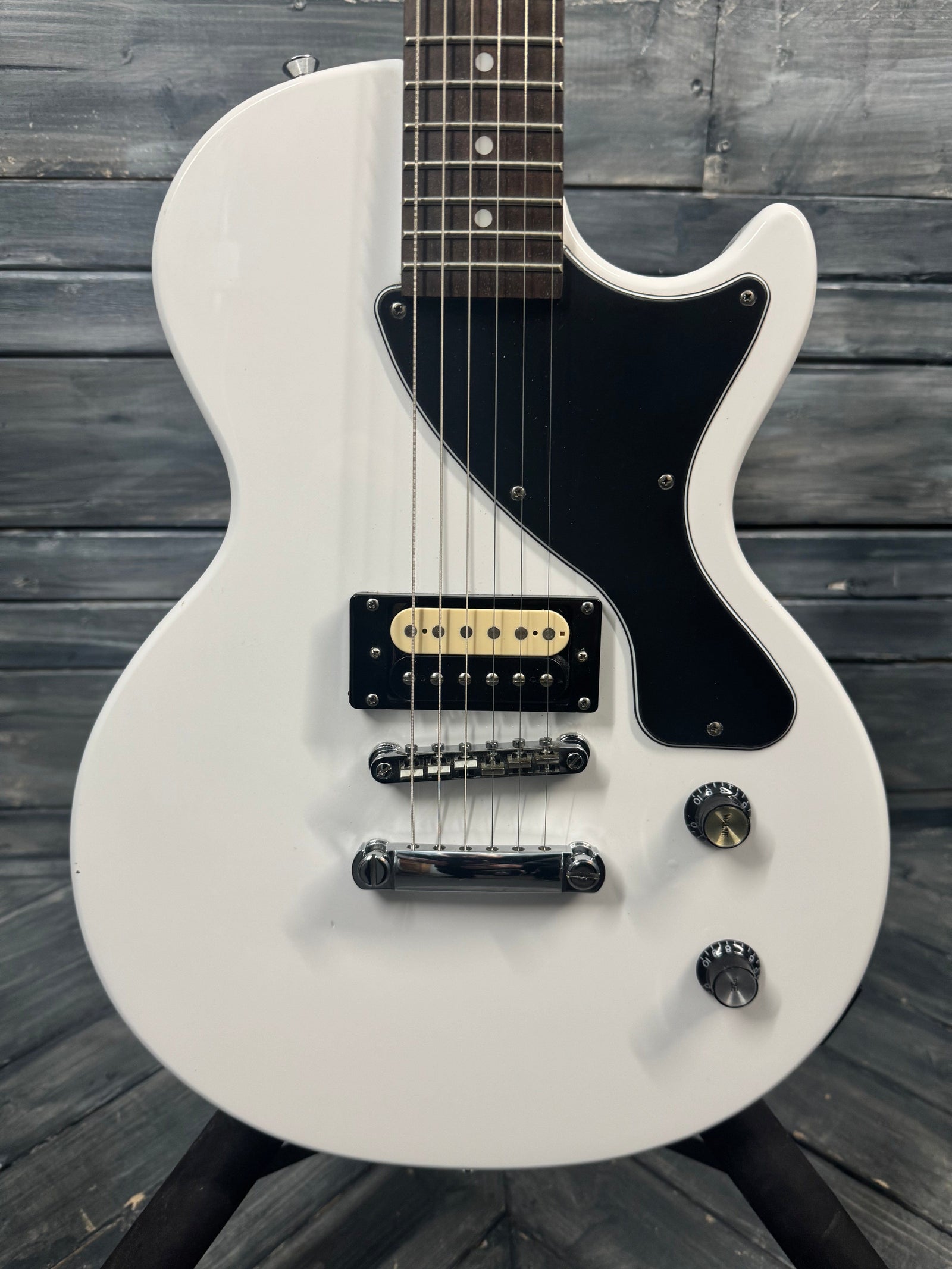 White electric guitar on a wooden background