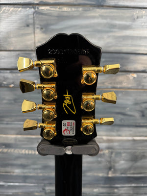 Guitar headstock with tuning pegs against a wooden background