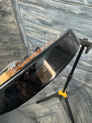 Guitar case with a guitar inside on a wooden floor