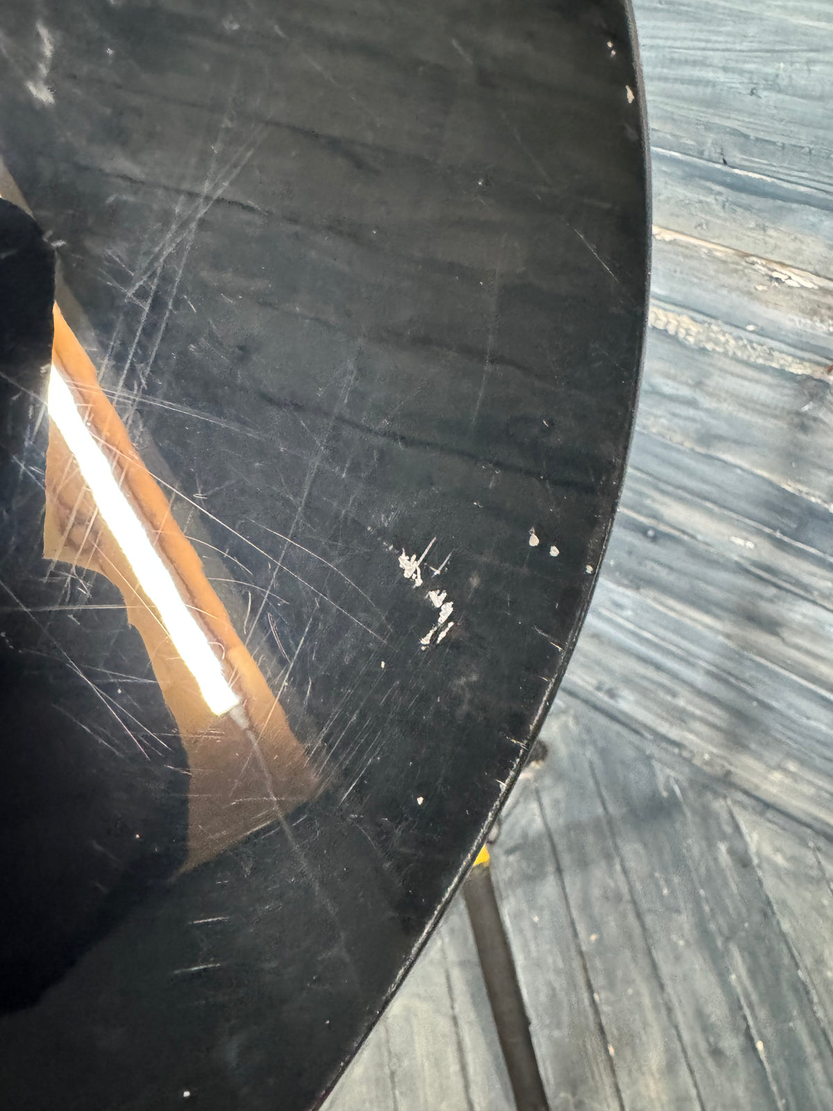 Scratched black surface on a wooden floor