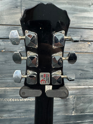Guitar headstock with tuning pegs on a wooden background