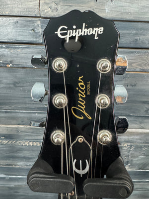 Epiphone guitar headstock with 'Jubilee' model text on a wooden background