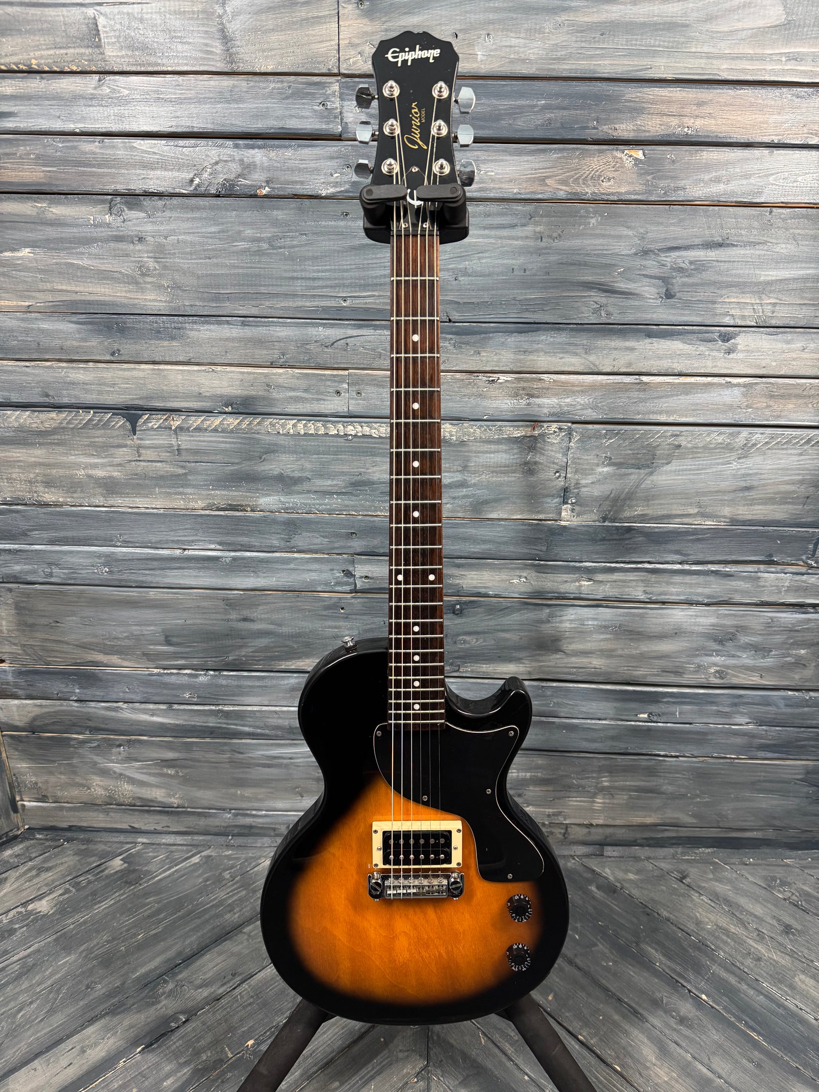 Electric guitar with a sunburst finish on a wooden background