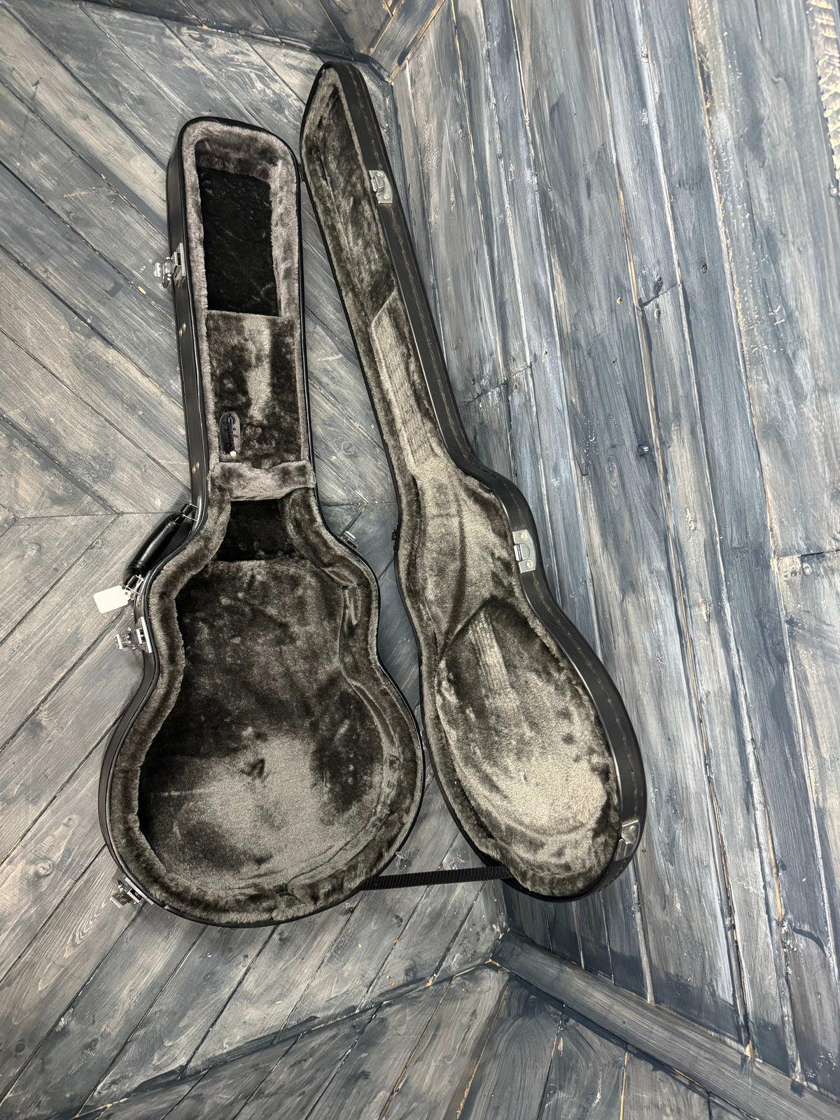 Worn guitar case on a wooden floor