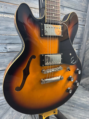 Electric guitar with a sunburst finish on a wooden surface