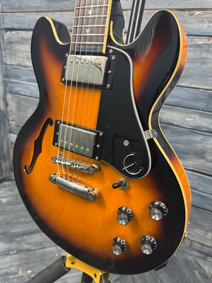 Electric guitar with a sunburst finish on a wooden background