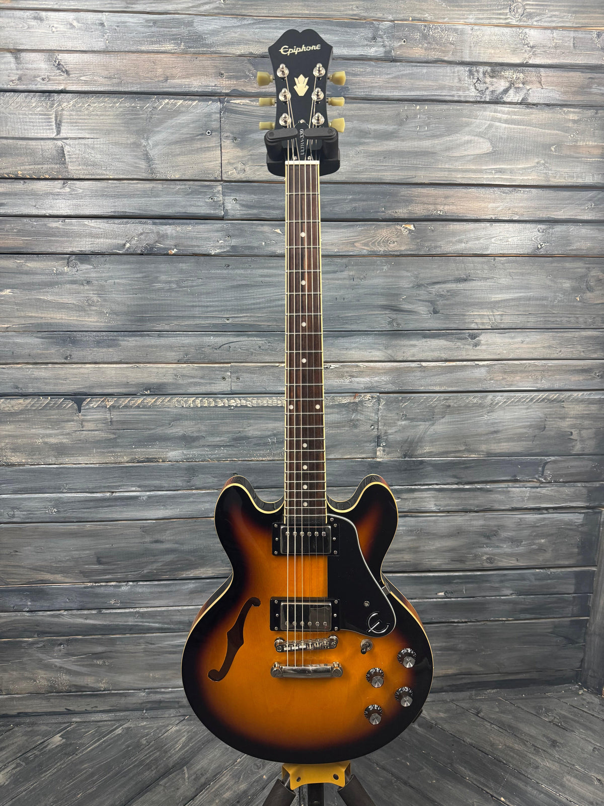 Electric guitar with a sunburst finish on a wooden background